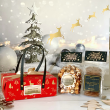 Load image into Gallery viewer, A Christmas-themed gift set featuring dark chocolate cookie thins in a red box with a Christmas tree and presents design, and a bag of gourmet popcorn with a mix of flavors.